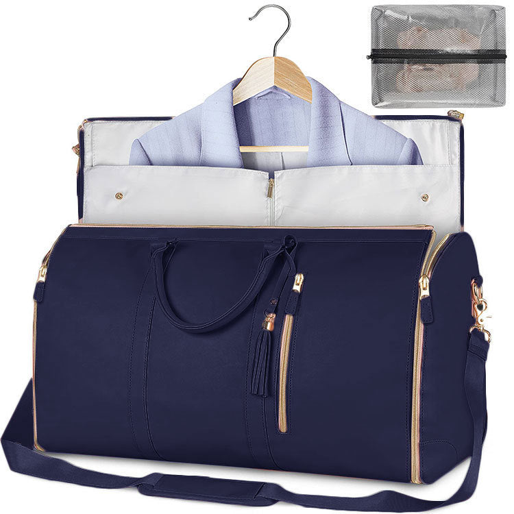 Foldable navy waterproof duffel bag with light trim, open interior, shoulder strap