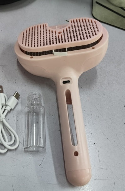 Pink self-cleaning pet grooming brush with vented comb head and charging port