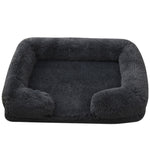 Dark gray plush dog bed with padded sides and rounded bolster base