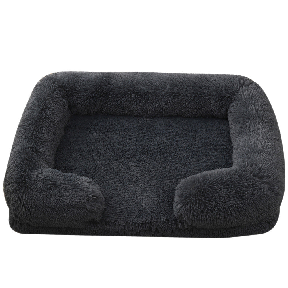 Dark gray plush dog bed with padded sides and rounded bolster base