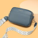 Genuine leather crossbody bag with blue textured leather and patterned wide strap