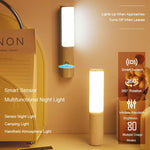 Wall-mounted motion sensor LED night light with glowing vertical panel and gray body