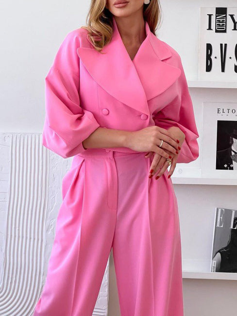 Pink short lapel jacket with long puff sleeves and matching high-waist trousers