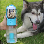 Portable dog water bottle with blue cup lid, held near a lying husky outdoors