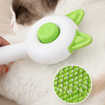 Self-cleaning pet brush close-up with green bristle pad and green button on cat
