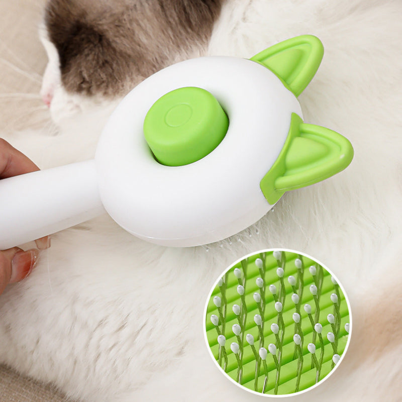 Self-cleaning pet brush close-up with green bristle pad and green button on cat