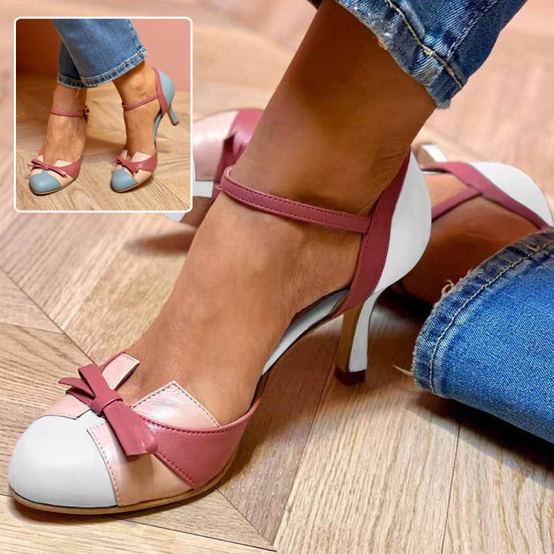 Women’s high heel pumps with pointed toe, bow detail, and ankle buckle strap, pink and light blue.