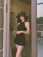 Front-facing one-piece swimsuit, high neck sleeveless top with flared skirt peplum, dark