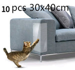 Translucent PVC sofa guard pad on blue sofa armrest with cat paw raised
