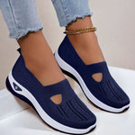 Navy blue mesh slip-on flat shoes with oval cutouts and white cushioned soles