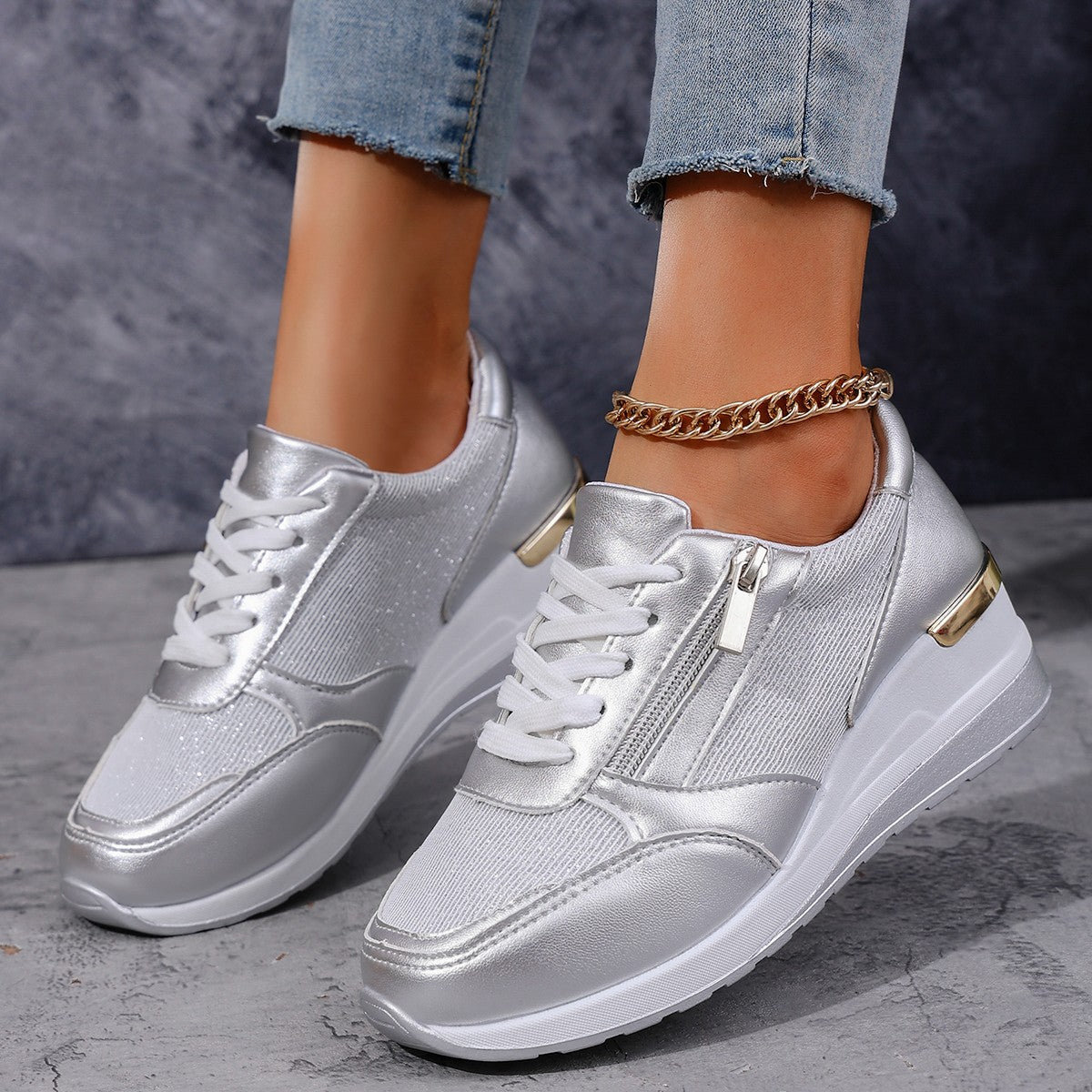 Women's silver lace-up sneakers with side zip, thick white sole and ankle chain detail