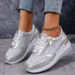 Women's silver lace-up sneakers with side zip, thick white sole and ankle chain detail