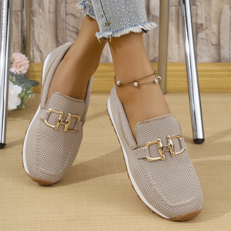 Khaki women’s canvas flat sneakers with gold horsebit-style detail, slip-on design.