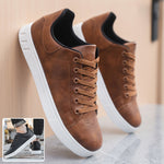 Brown lace-up flat casual shoes with round toe, black collar, and white textured sole