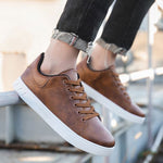 Brown lace-up flat casual shoes with round toe, brown laces, and white textured sole