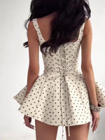 White polka dot backless mini dress with crisscross lace-up and gathered bow