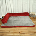 Red pet dog bed with ribbed bolster and light gray plush mat