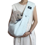 Light gray pet shoulder carrier sling with plush dog in front pouch