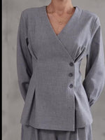 Light gray V-neck button top with long sleeves and wide-leg pants, front close-up