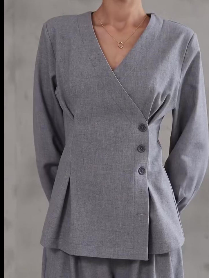 Light gray V-neck button top with long sleeves and wide-leg pants, front close-up