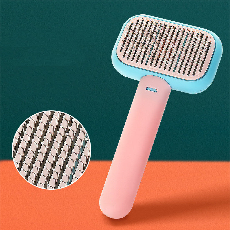 Pet grooming brush with stainless pins, light blue head and pink handle