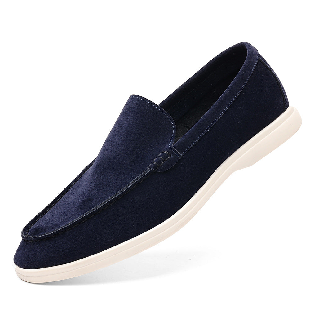 Navy suede slip-on loafers with white sole, stitched moc toe detail