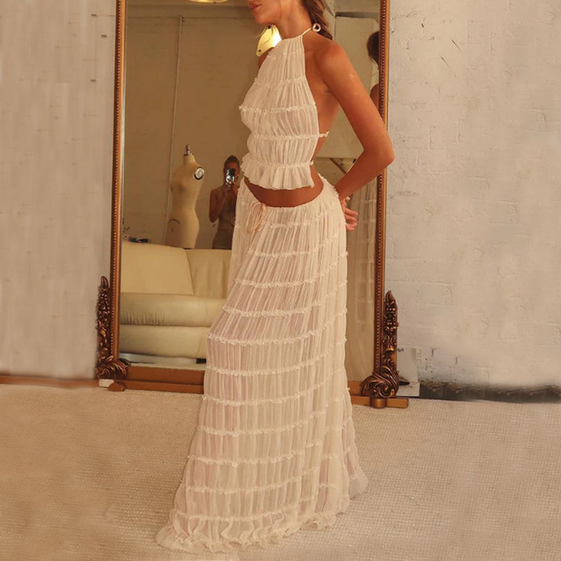 White halter crop top and pleated long skirt set with tiered ruffles, standing view