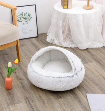Round plush pet bed in white/cream, empty bed with cushioned interior
