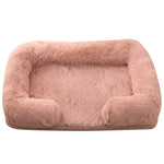 Pink plush dog bed with padded sides and rounded bolster base