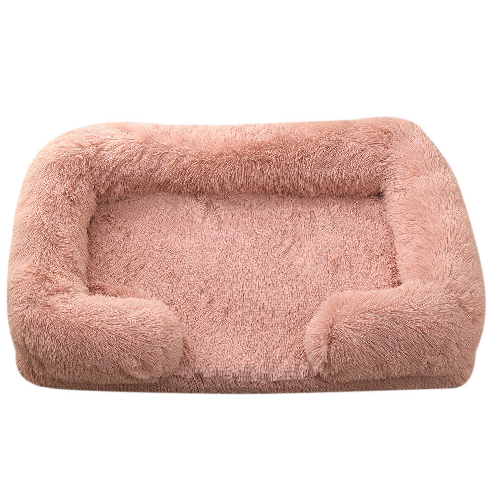 Pink plush dog bed with padded sides and rounded bolster base