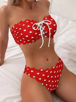 Red printed tube-top bikini with white heart pattern, drawstring tie-front, scalloped high-waist briefs