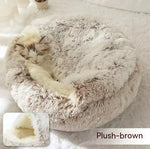 Round plush pet bed with cave opening; light beige plush with pet lying inside
