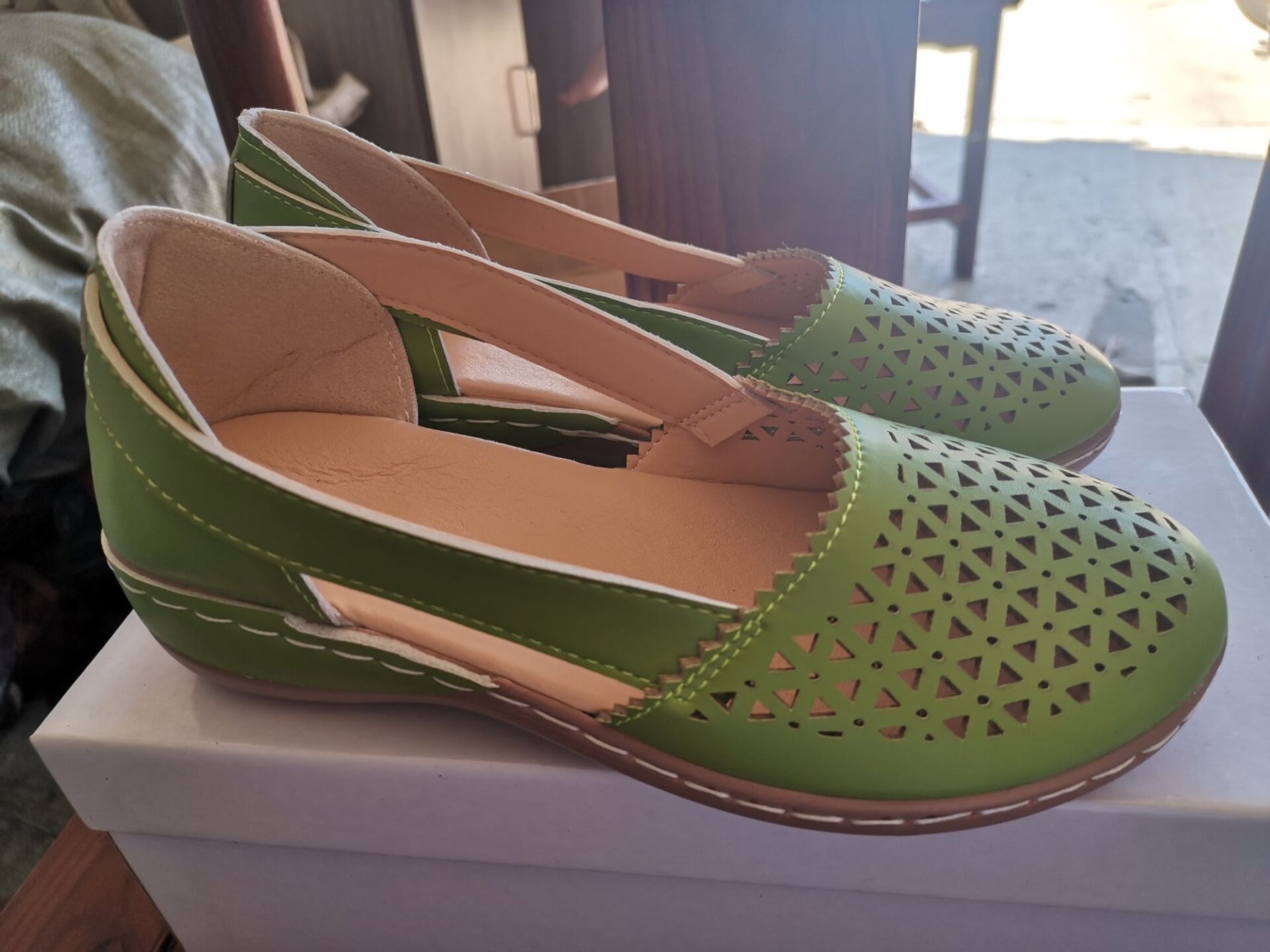 Green round-toe wedge loafers with laser-cut design and cushioned insole