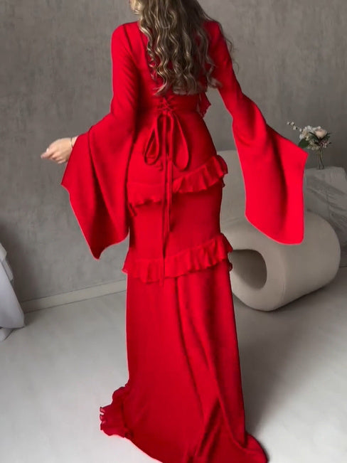 Red V-neck maxi dress with tied neckline and tiered ruffles, flared sleeves