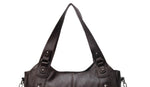 Women’s retro PU handbag top handles in dark brown, with double buckle strap attachments.