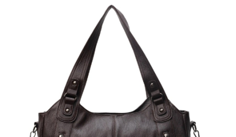 Women’s retro PU handbag top handles in dark brown, with double buckle strap attachments.