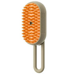 Electric steam pet brush with orange silicone bristles and beige handle