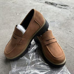 Women’s matte brown flat loafer shoes with round toe, buckle strap, and thick tread sole