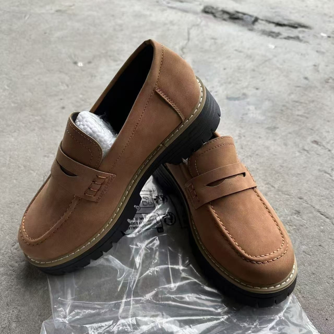 Women’s matte brown flat loafer shoes with round toe, buckle strap, and thick tread sole