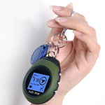 Green mini GPS tracker with key ring, held in hand
