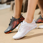 White water shoes with lace-up front and textured mesh upper on a foot.