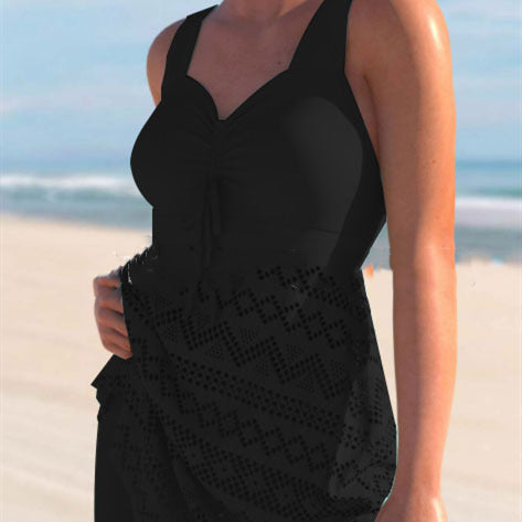 Black lace one-piece swimsuit with padded cups, tie-front detail, and patterned lace skirt panel