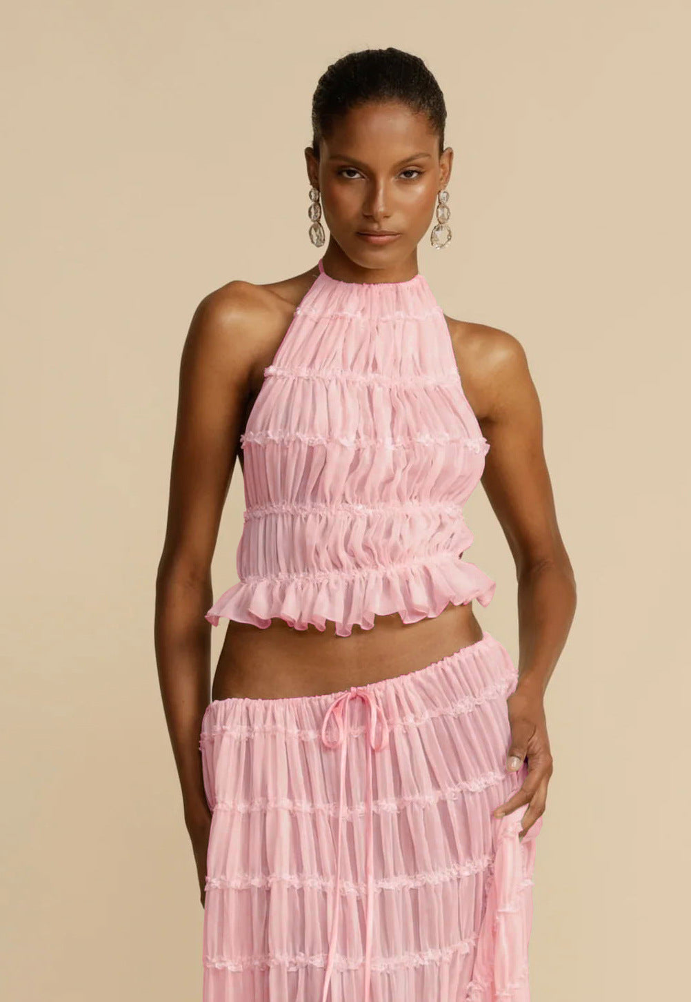Pink halter crop top and pleated long skirt set with tiered ruffles and elastic waist