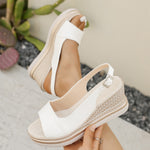 Women’s white wedge platform sandals with open toe, ankle strap, and buckle closure