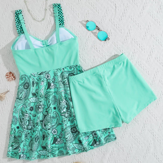 Turquoise bikini top with polka-dot straps paired with teal patterned skirt shorts