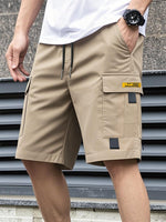 Men's khaki utility shorts with drawstring, high waist, and cargo flap pockets