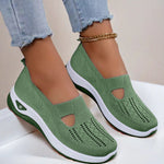 Green mesh slip-on flat shoes with oval cutouts and white cushioned soles