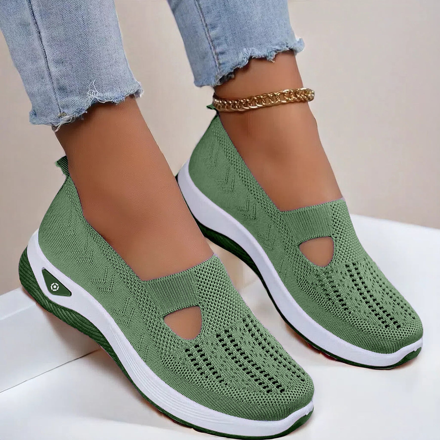 Green mesh slip-on flat shoes with oval cutouts and white cushioned soles