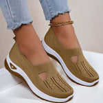 Tan mesh slip-on flat shoes with oval cutouts and white cushioned soles